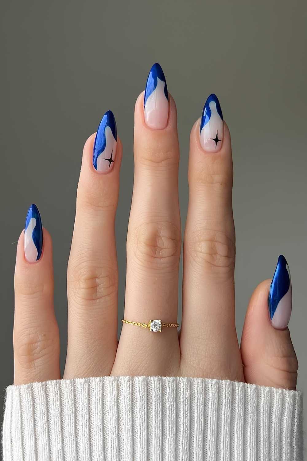 Abstract sapphire blue French mani with celestial art