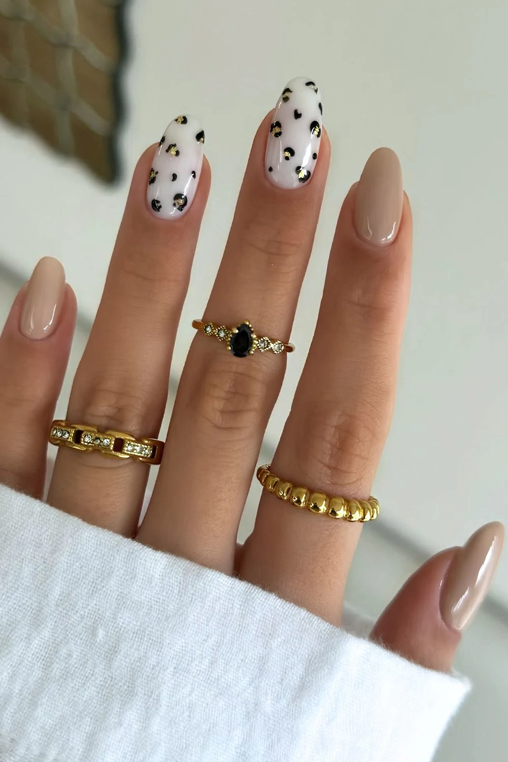 Beige and white almond mani with animal print tip accents