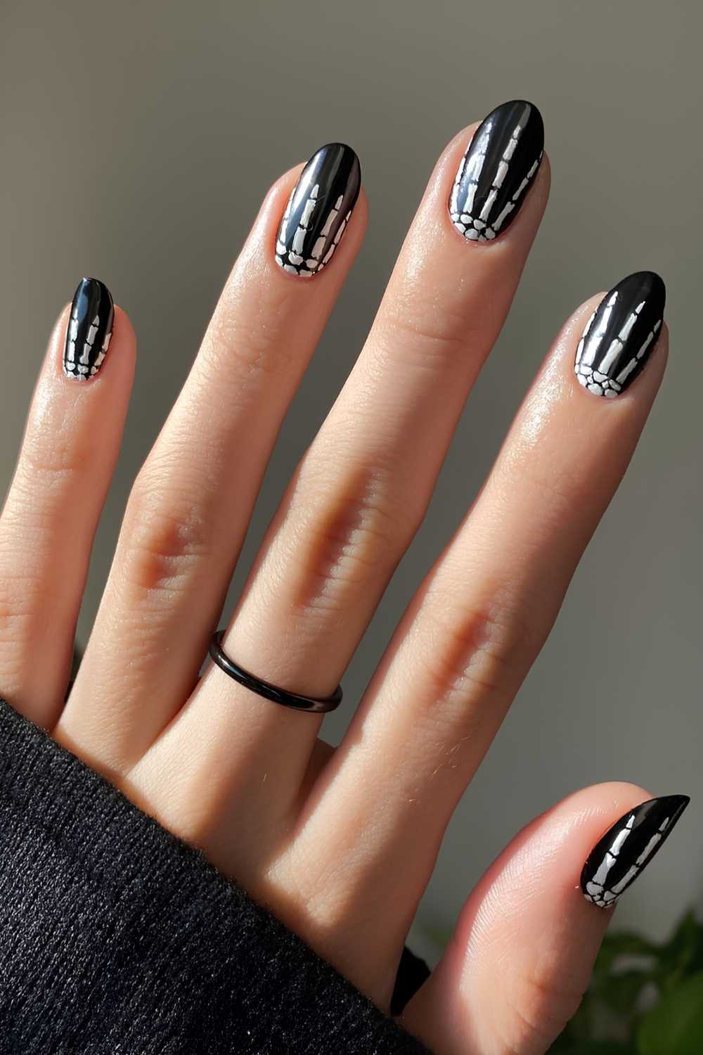 Black nails with skeleton hands design