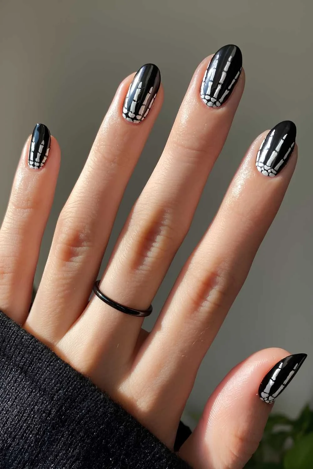 Black nails with skeleton hands design