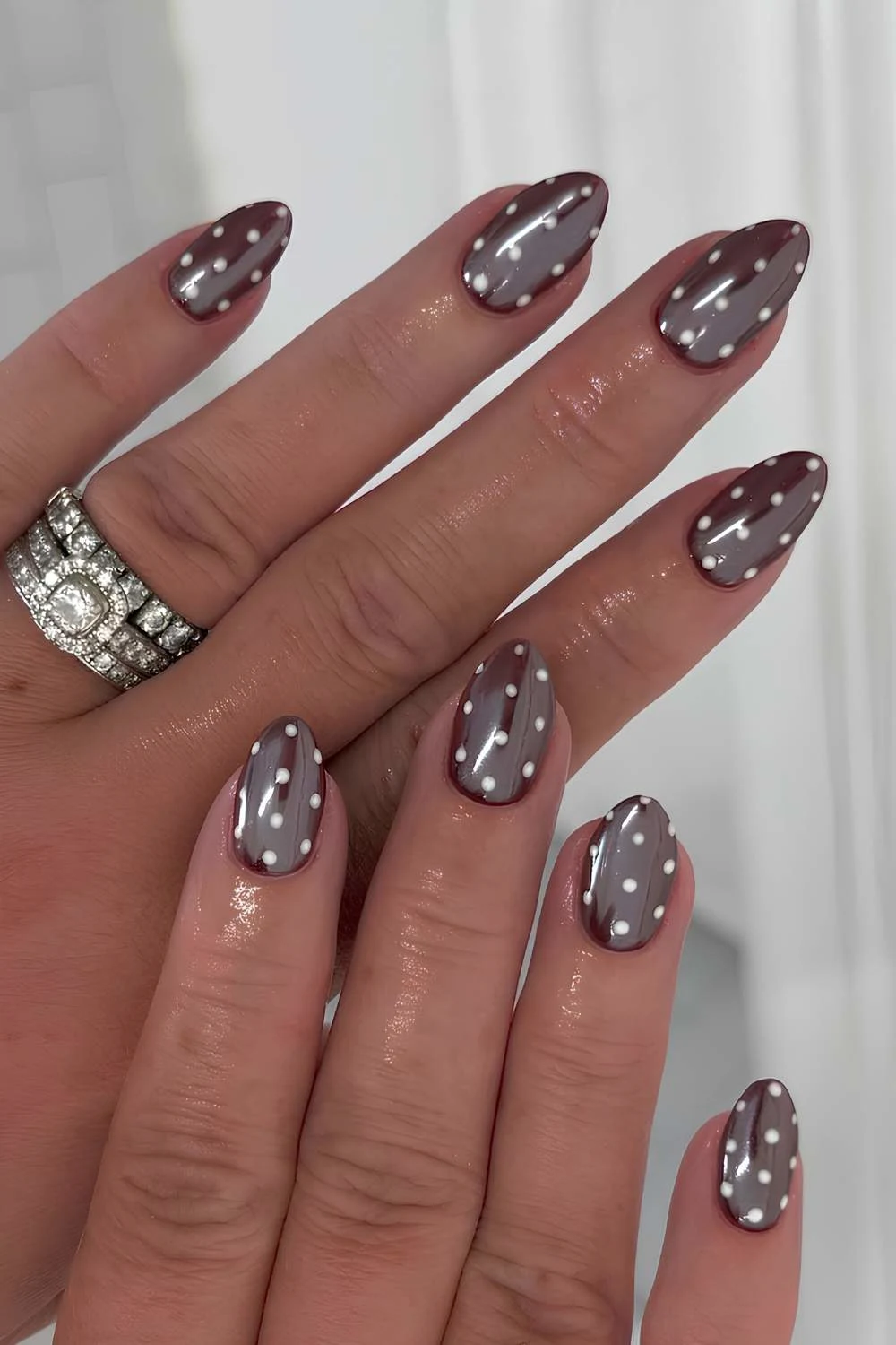 Brown chrome nails with polka dots
