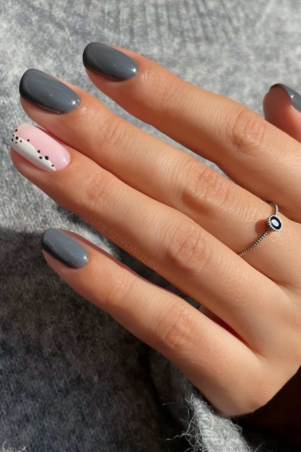 Dark grey nails with abstract white accents