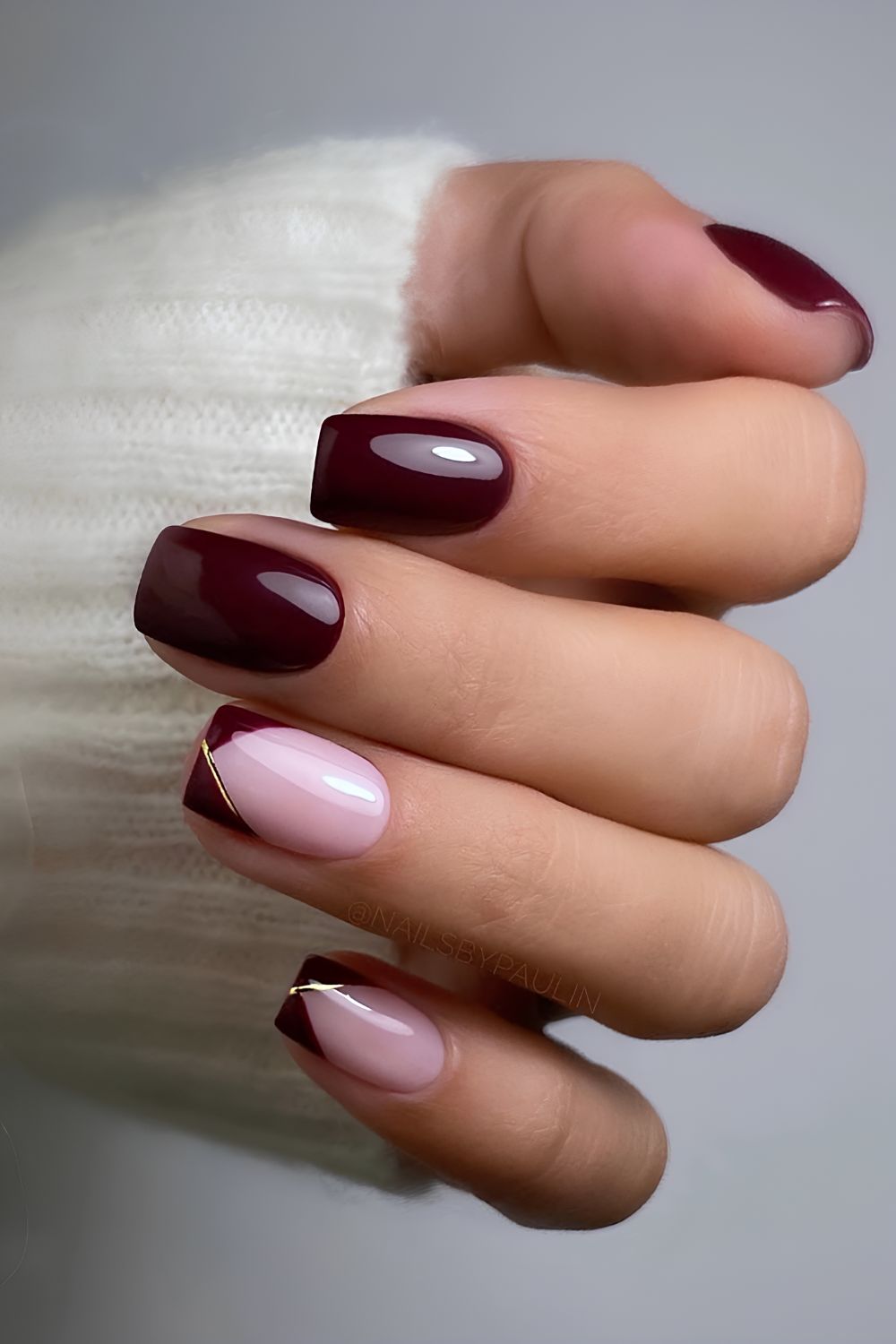 Dark red nails with gold chrome lines