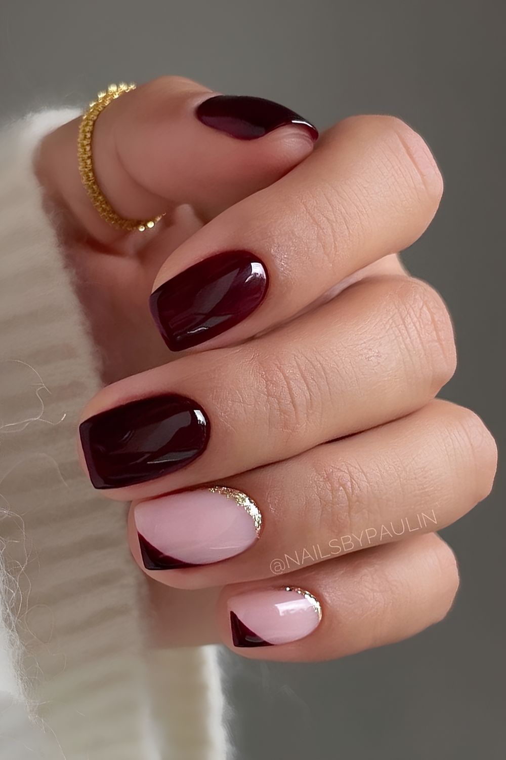 Dark red nails with gold glitter accent