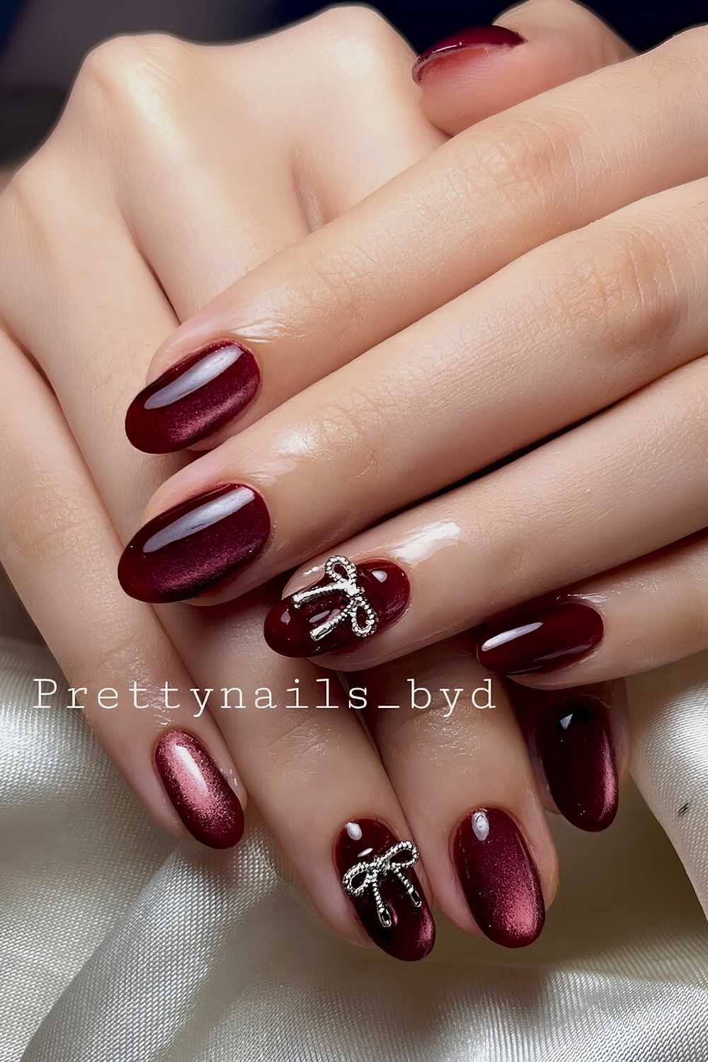 Deep red cat eye nails with bows