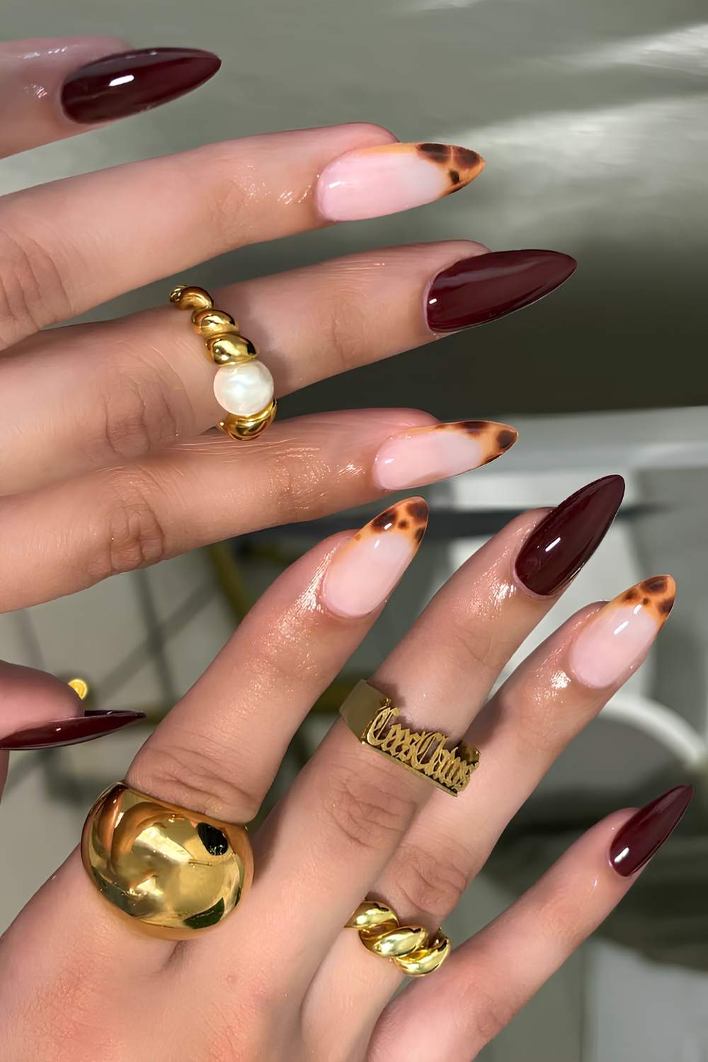 Deep red manicure with tortie shell accents