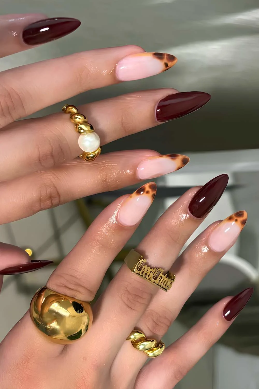 Deep red manicure with tortie shell accents