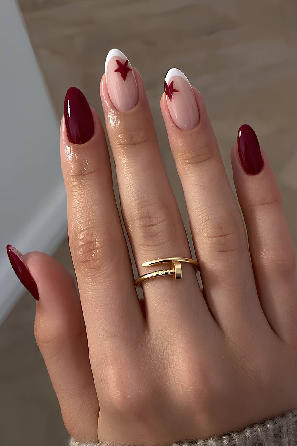 Deep red nails with accent star art