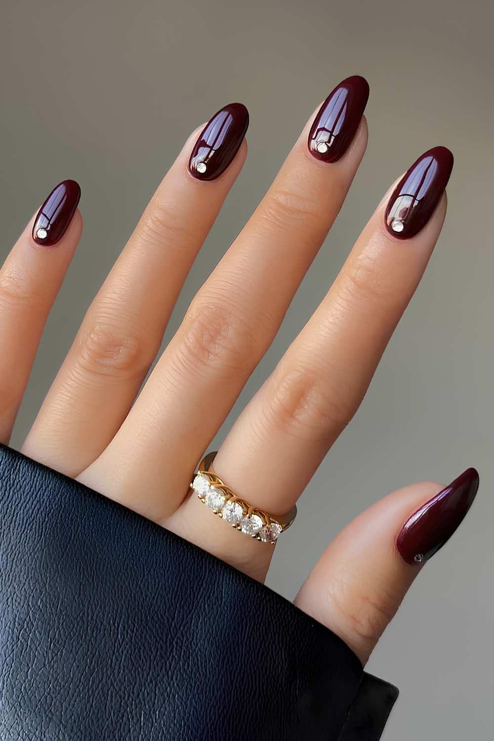 Maroon nails with accent rhinestones