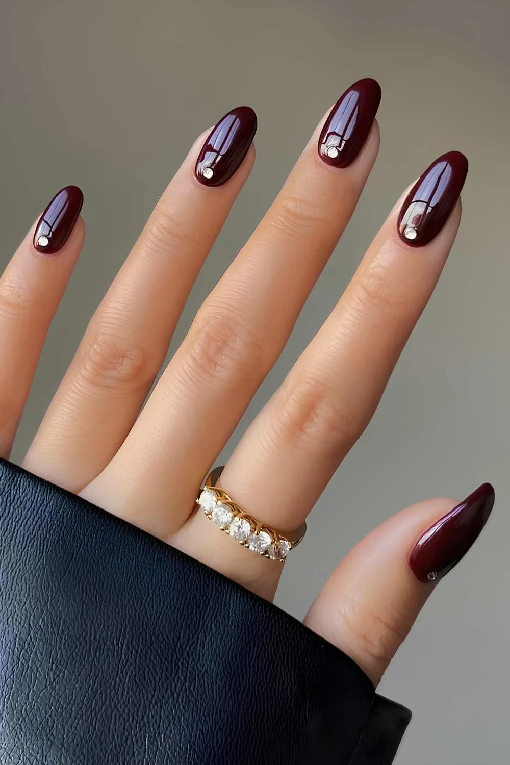 Maroon nails with accent rhinestones