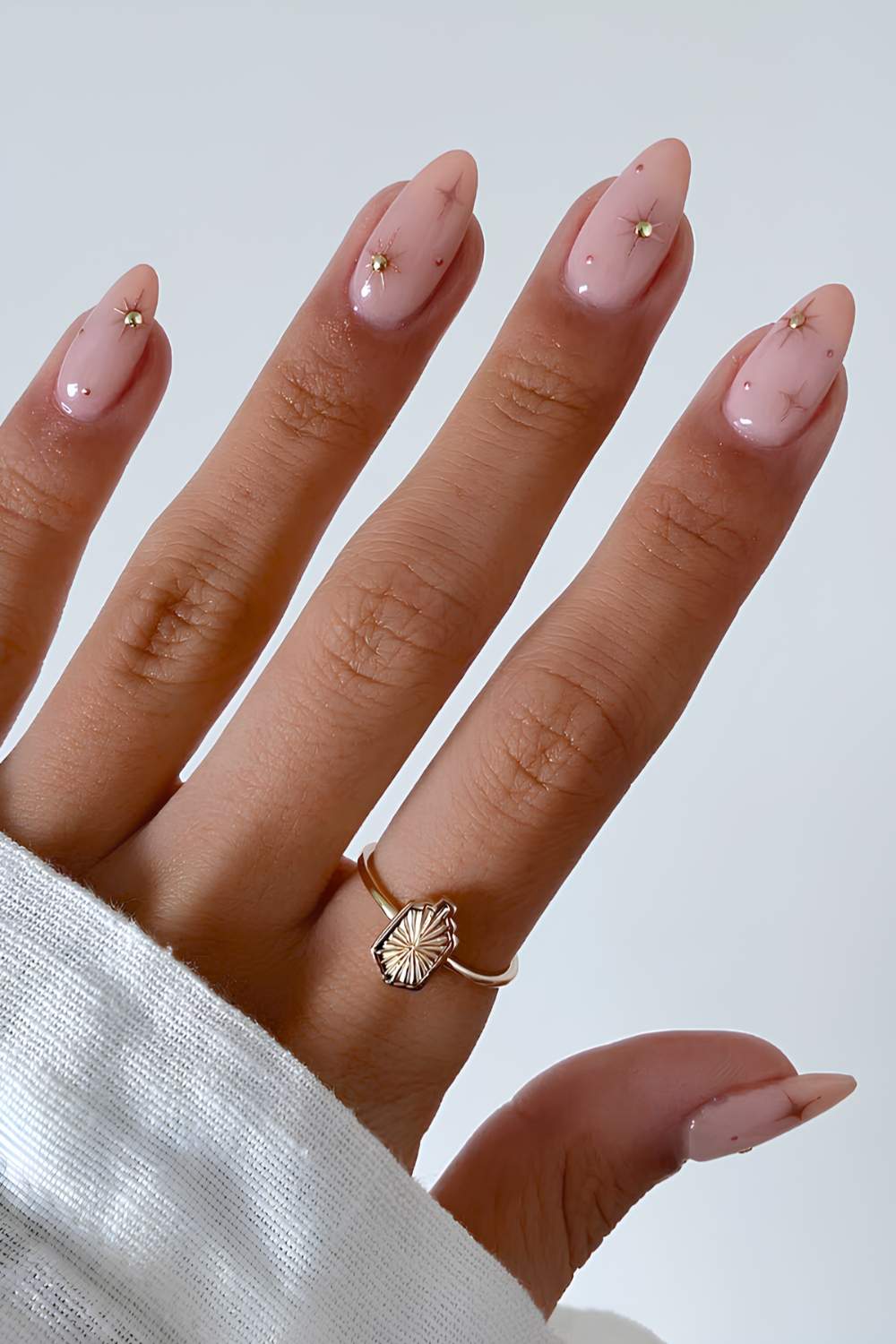 Milky pink nails with gold celestial art