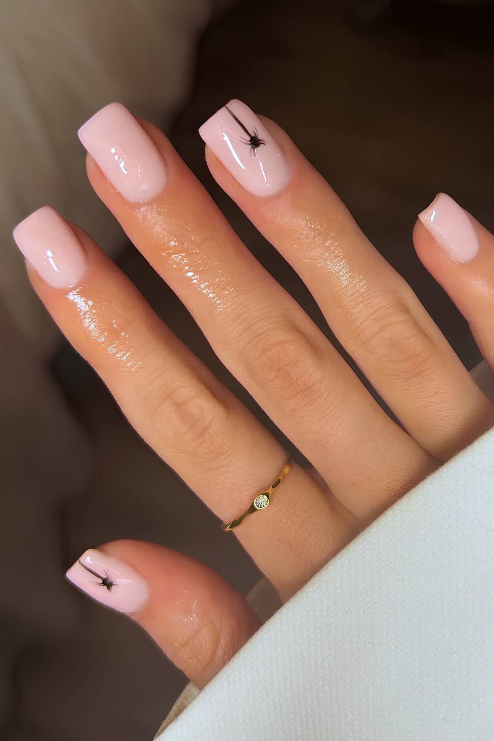Milky pink nails with spider art