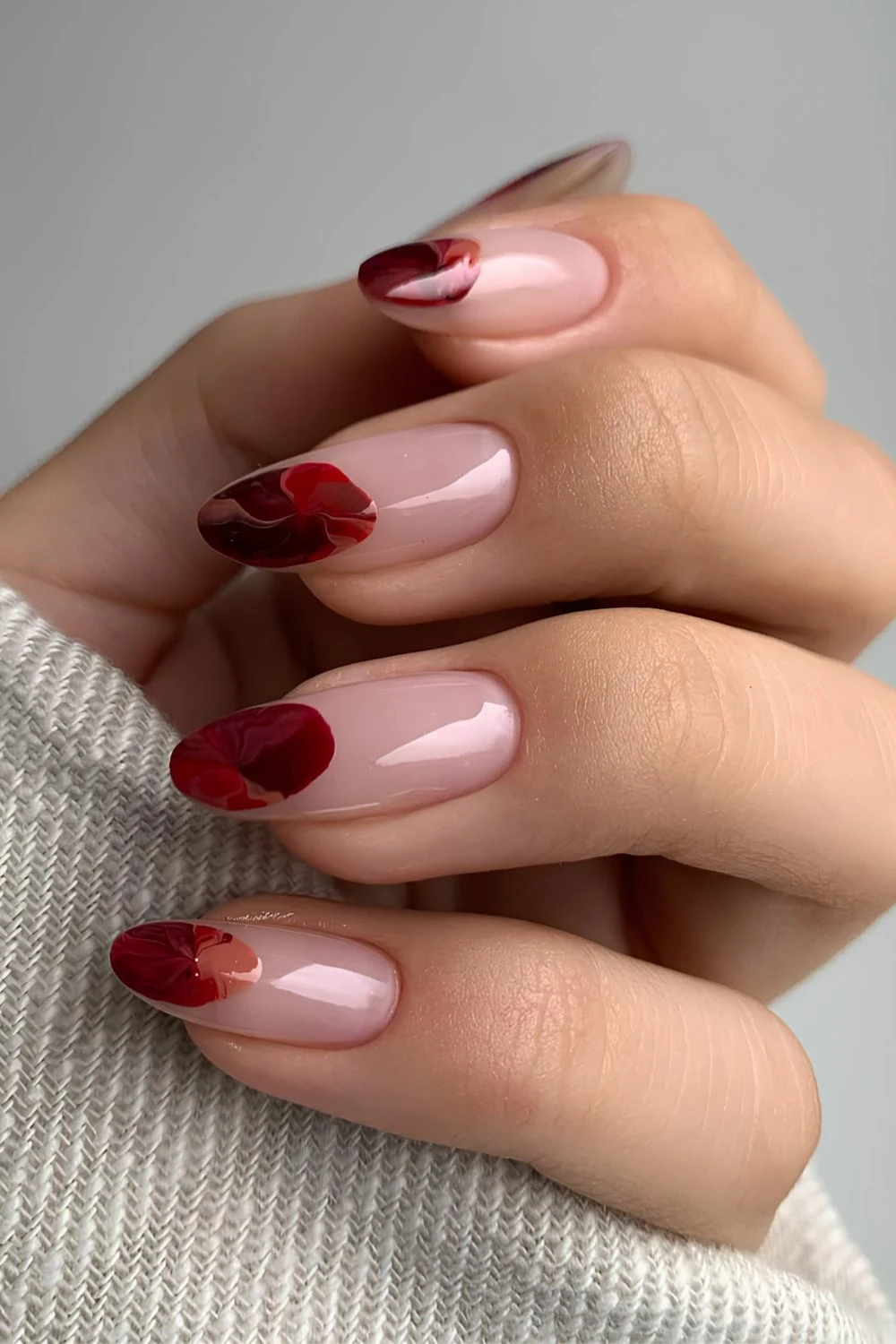 Natural almond nails with dark red circle accents