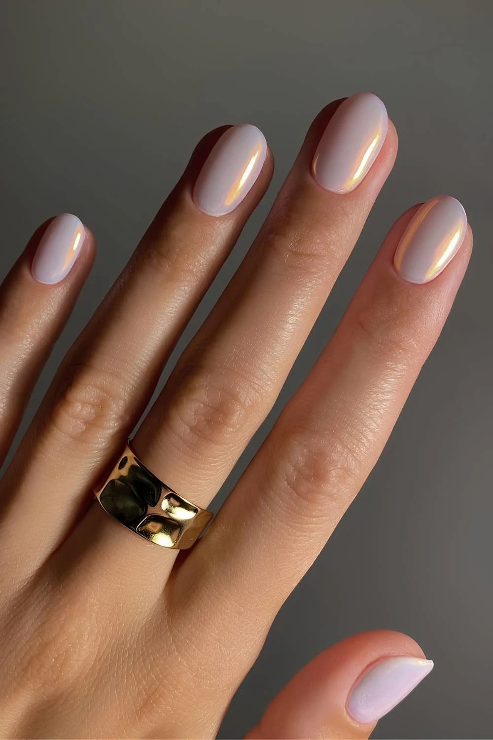 Opal-inspired nails with chrome effect