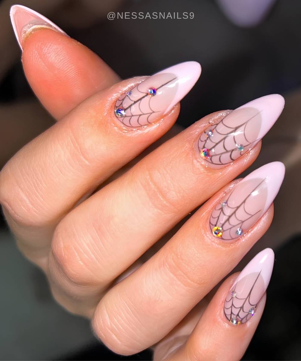 Pink French mani with spiderwebs and gems