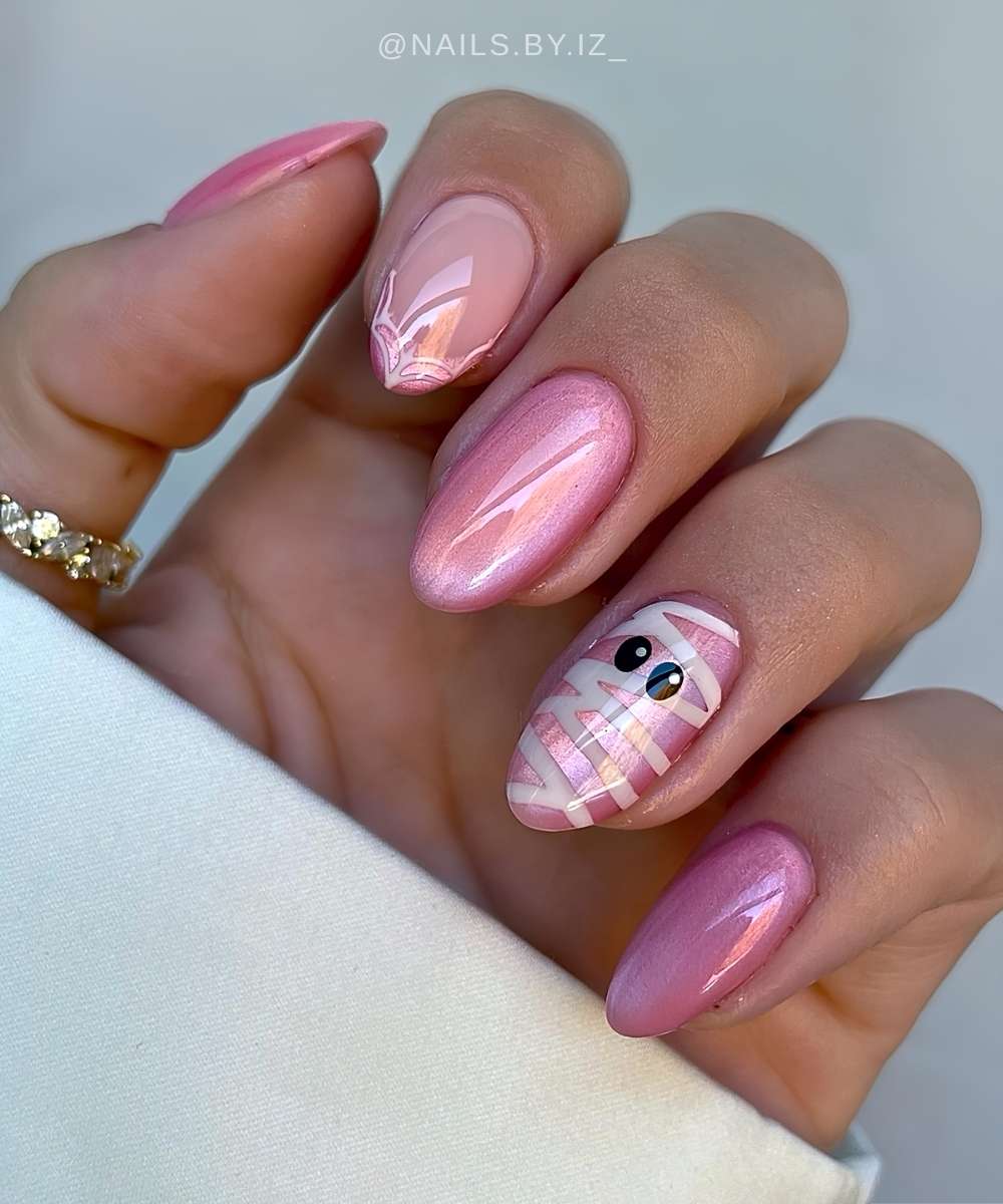 Pink cat eye nails with mummy eyes art