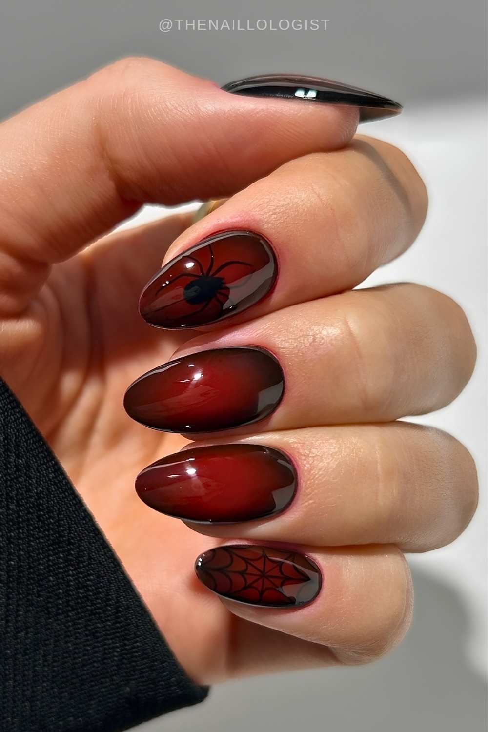 Red and black aura nails with spider art