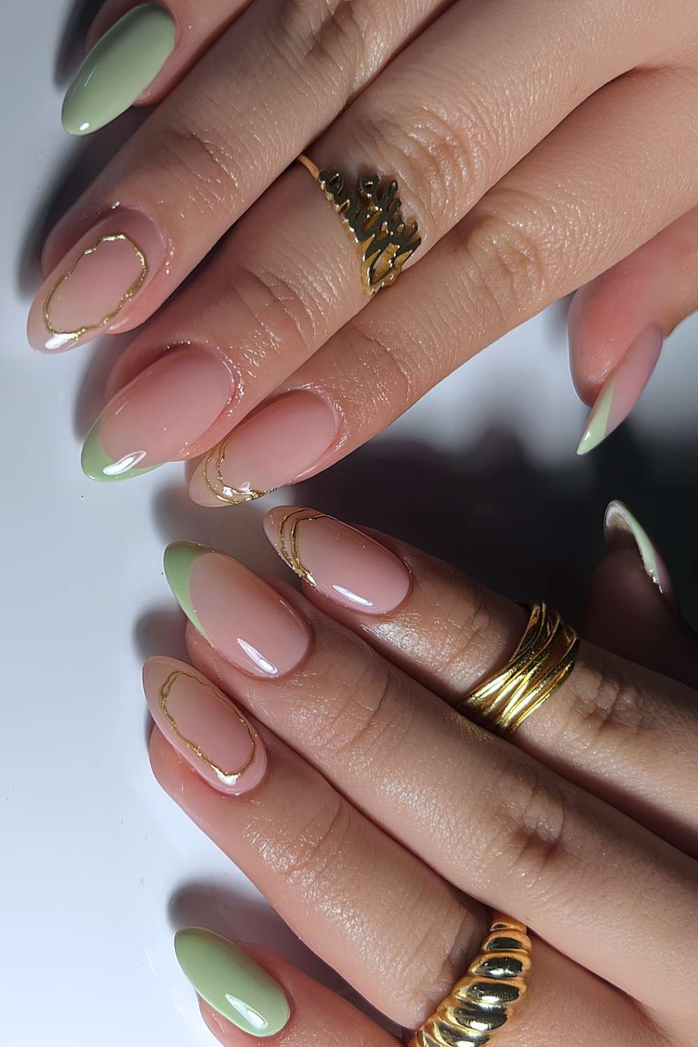 Sage green nails with gold detailing