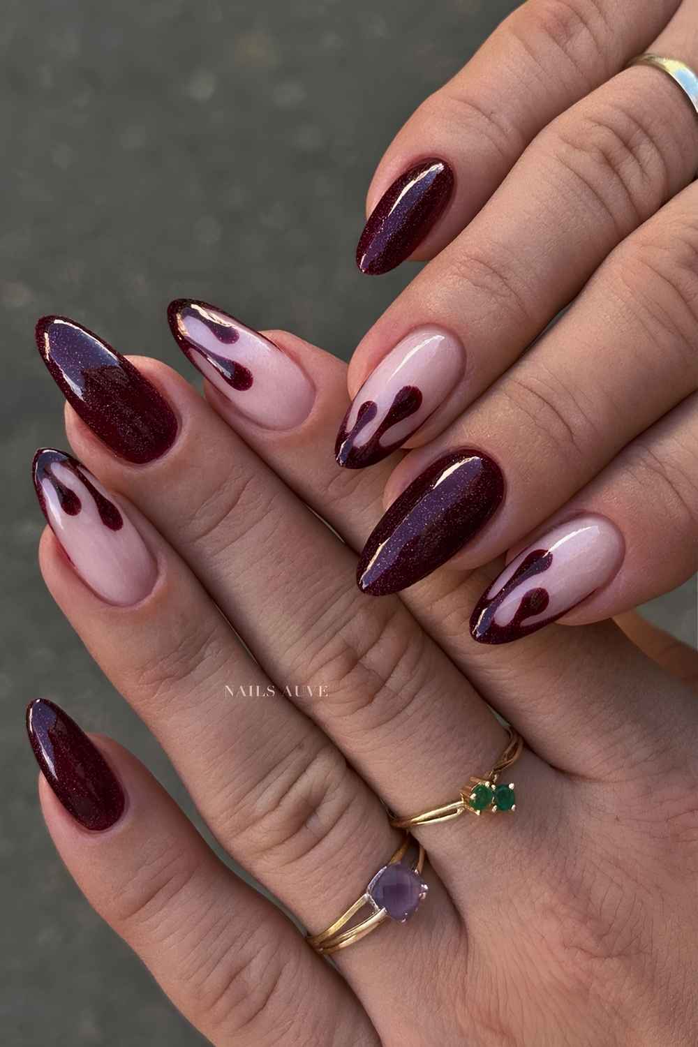 Shimmery dark red nails with blood drip art