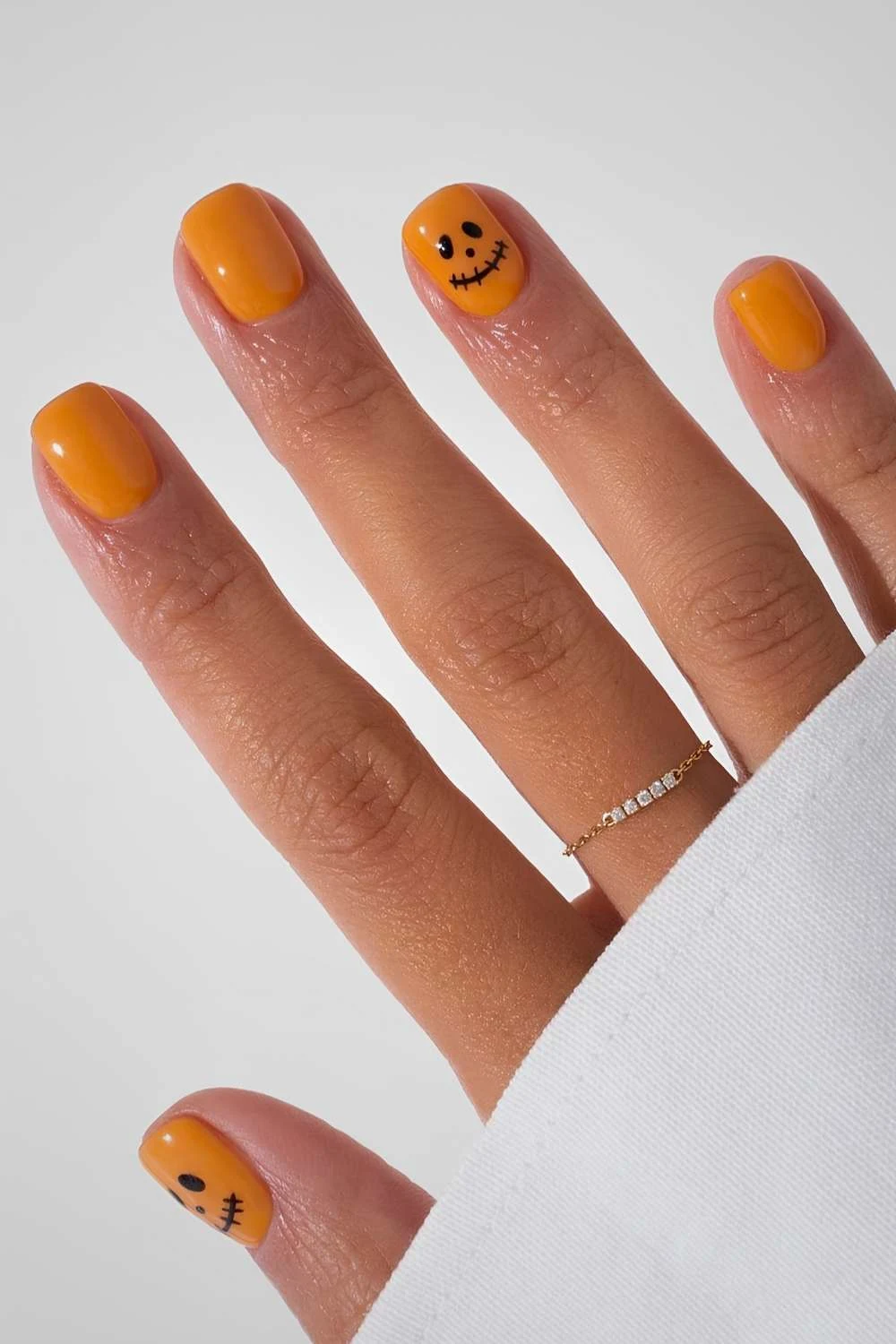 Short orange nails with Jack O Lantern art