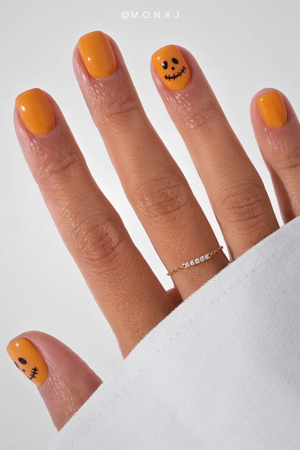 Short orange nails with Jack O Lantern face