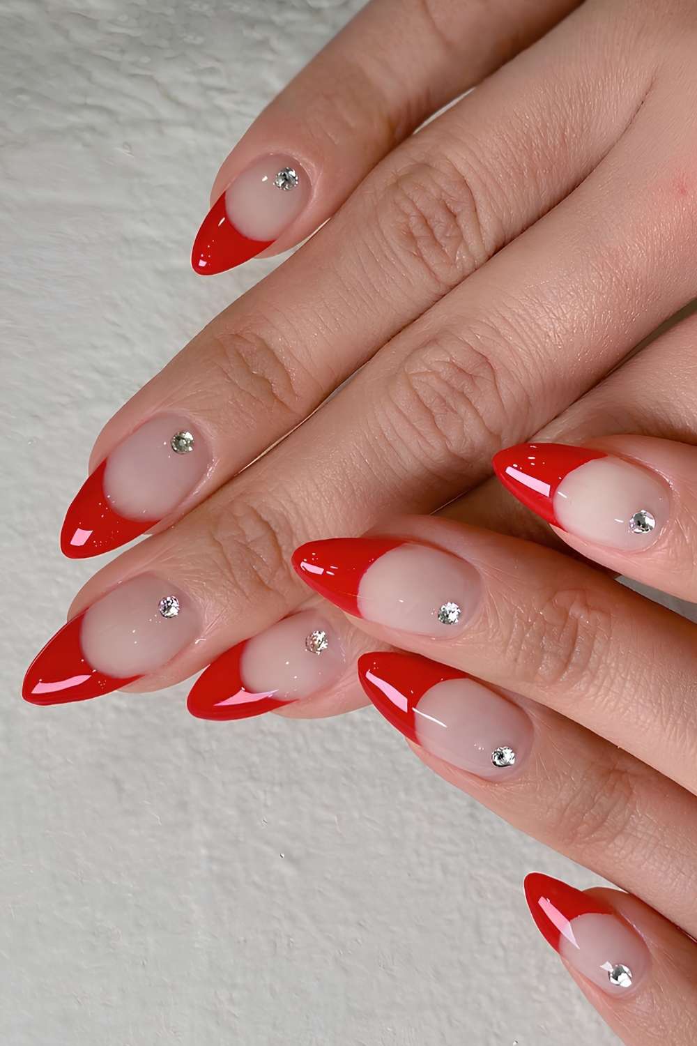 Thick red French nails with rhinestones
