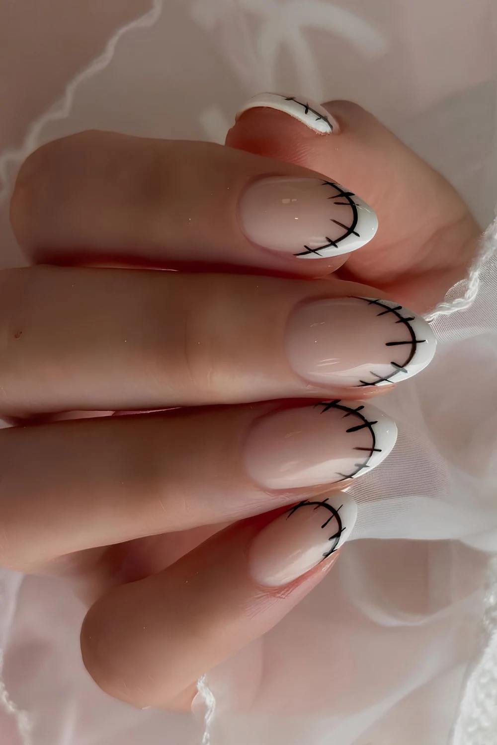 White French mani with black stitch art