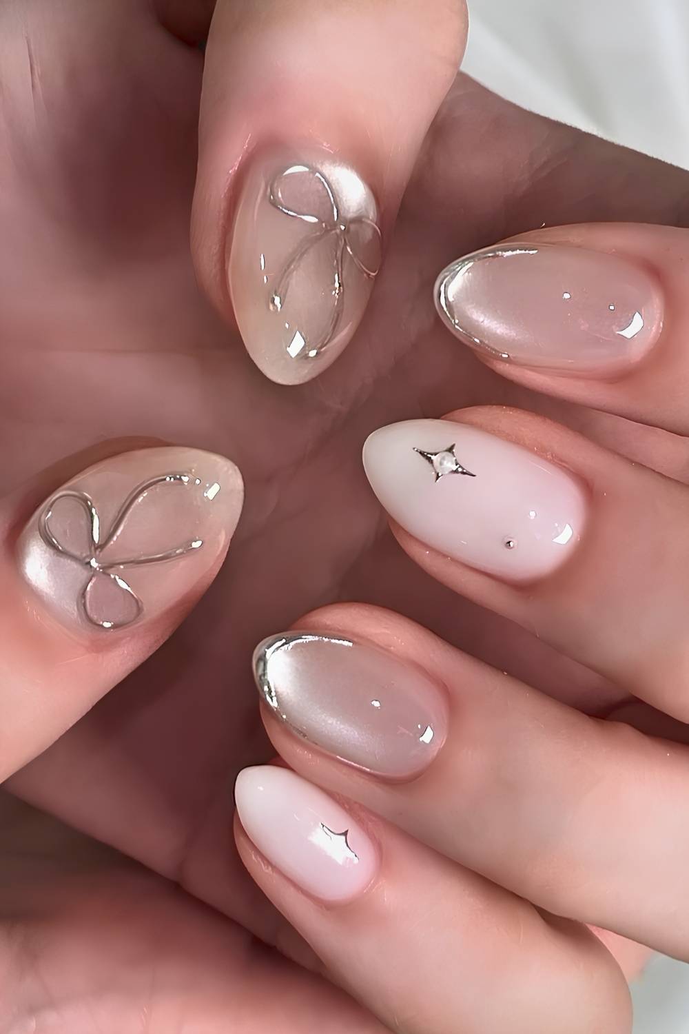 White nails with glass effect and bow accents
