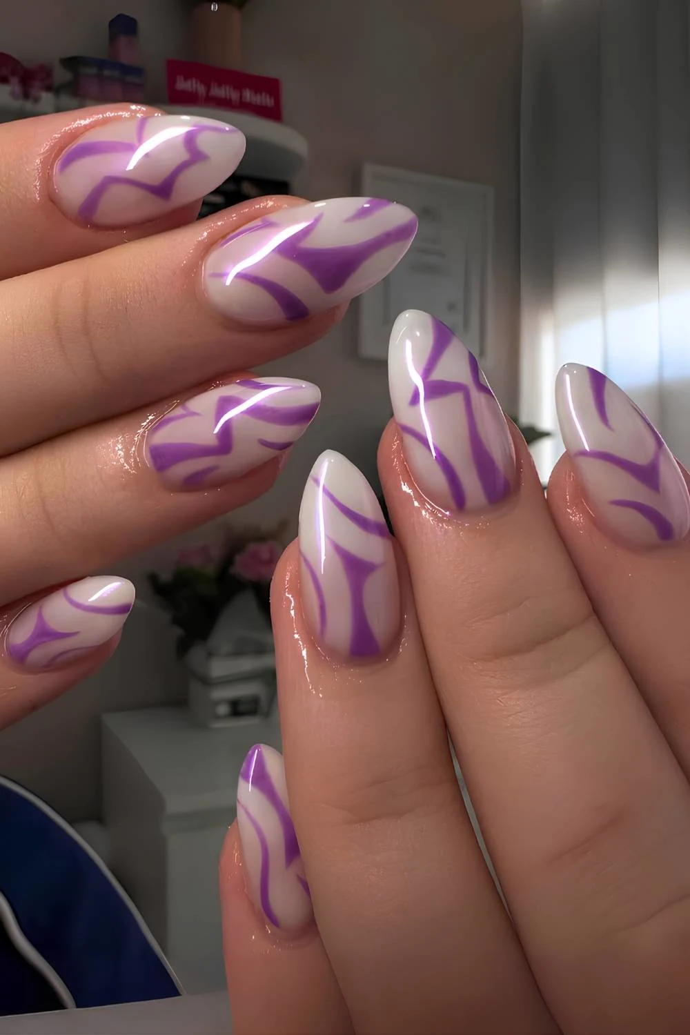 White nails with purple K-Pop Demon Hunters art