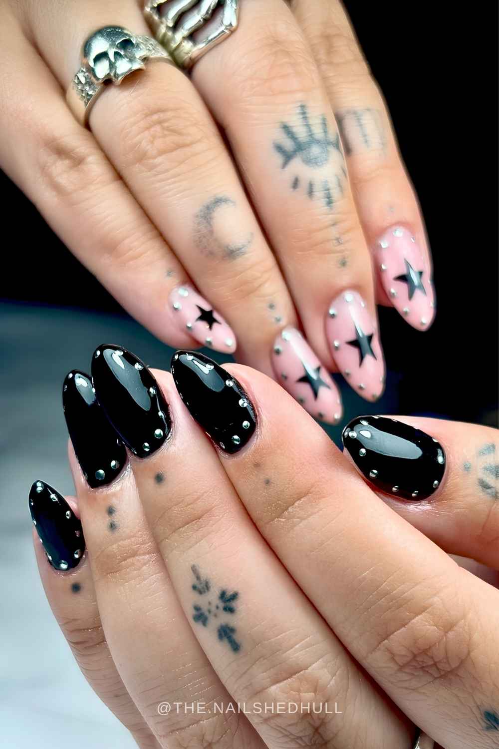 Black and pink nails with stars and silver halo accents