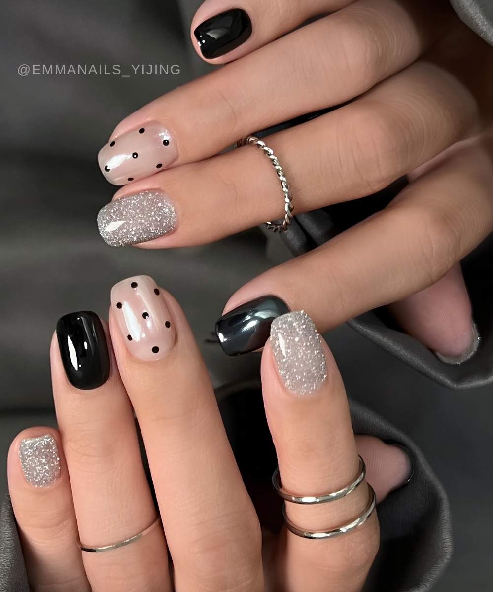Black and silver nails with glitter and polka dots