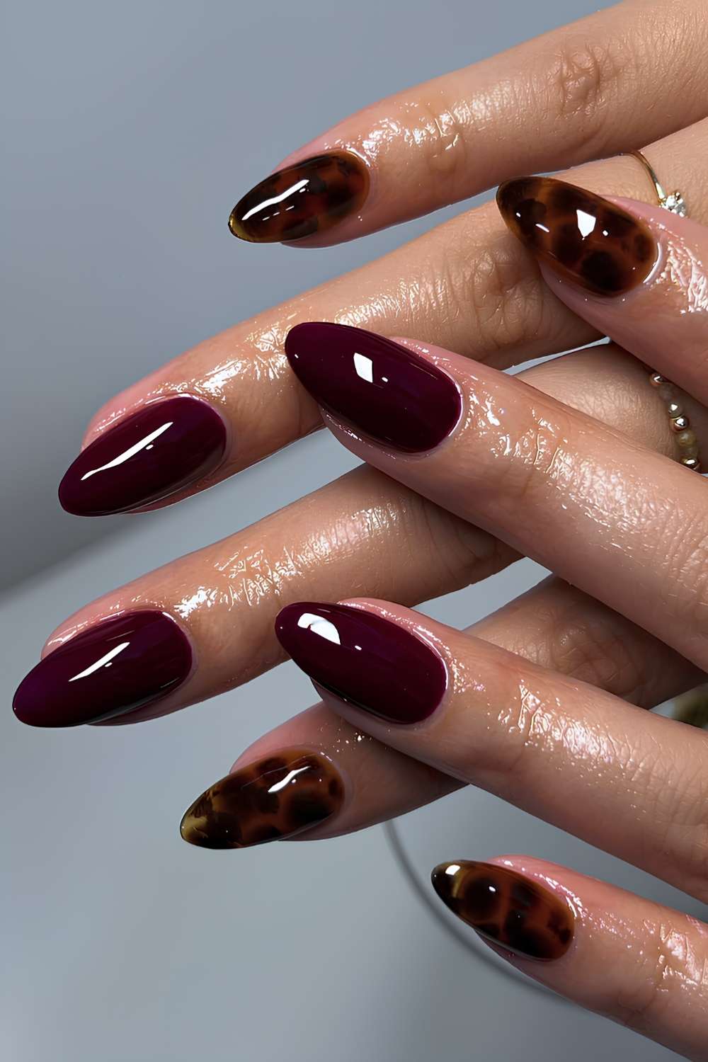 Dark red nails with tortie shell accents
