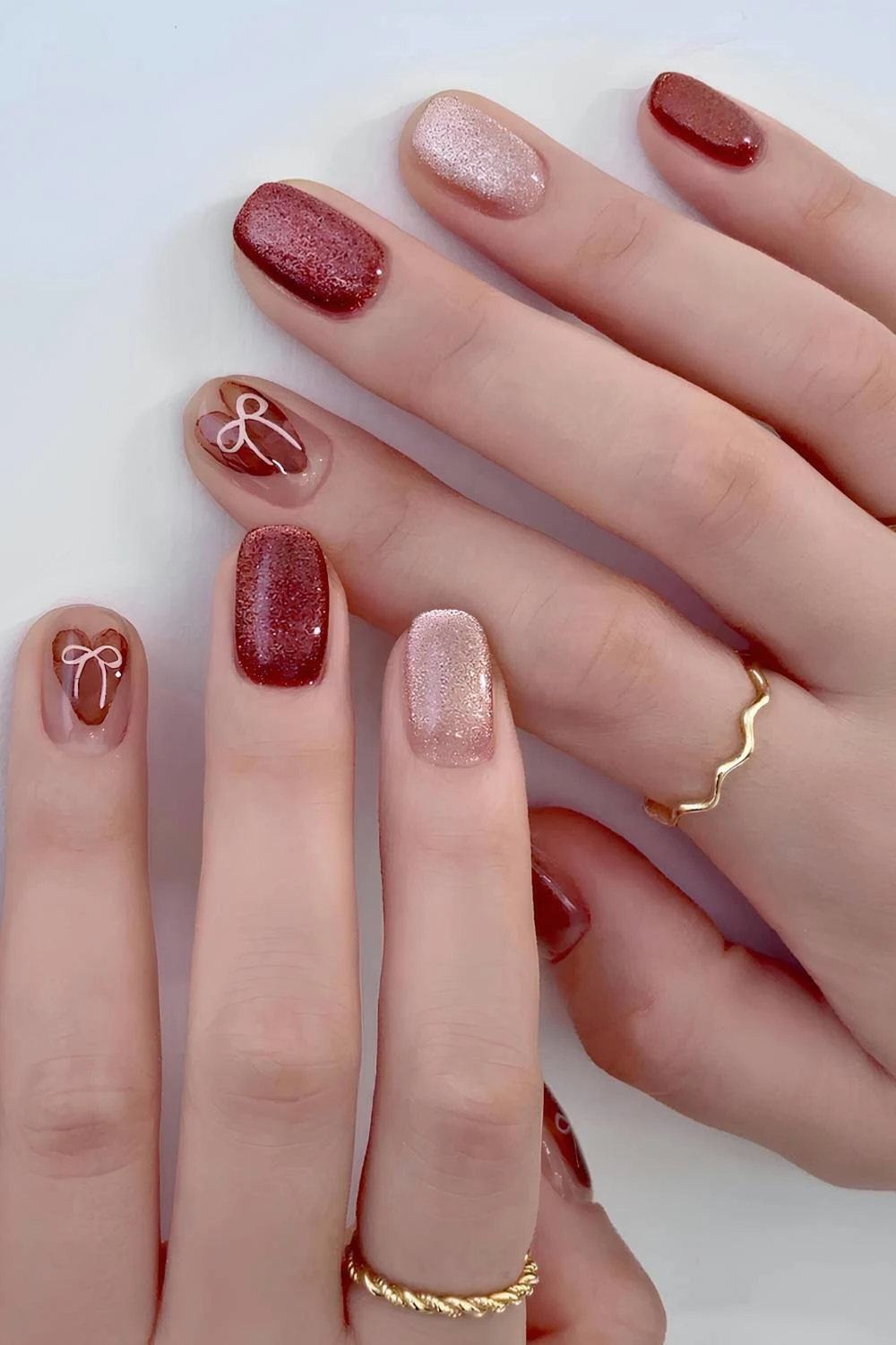 Maroon and gold velvet nails with bows