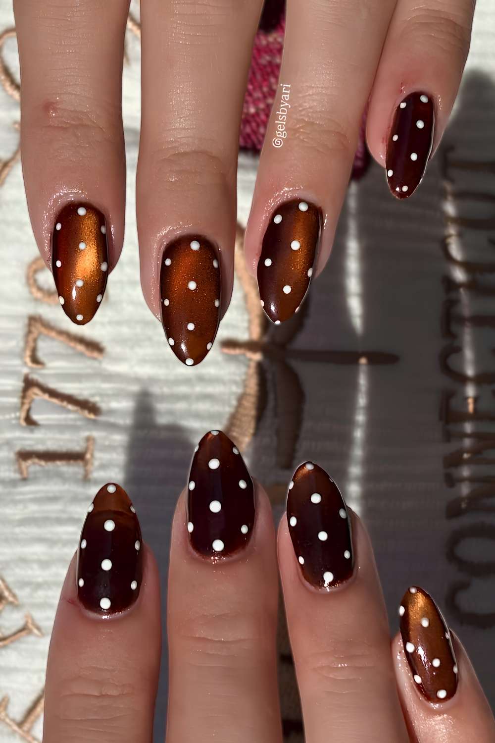 Brown cat eye nails with polka dots
