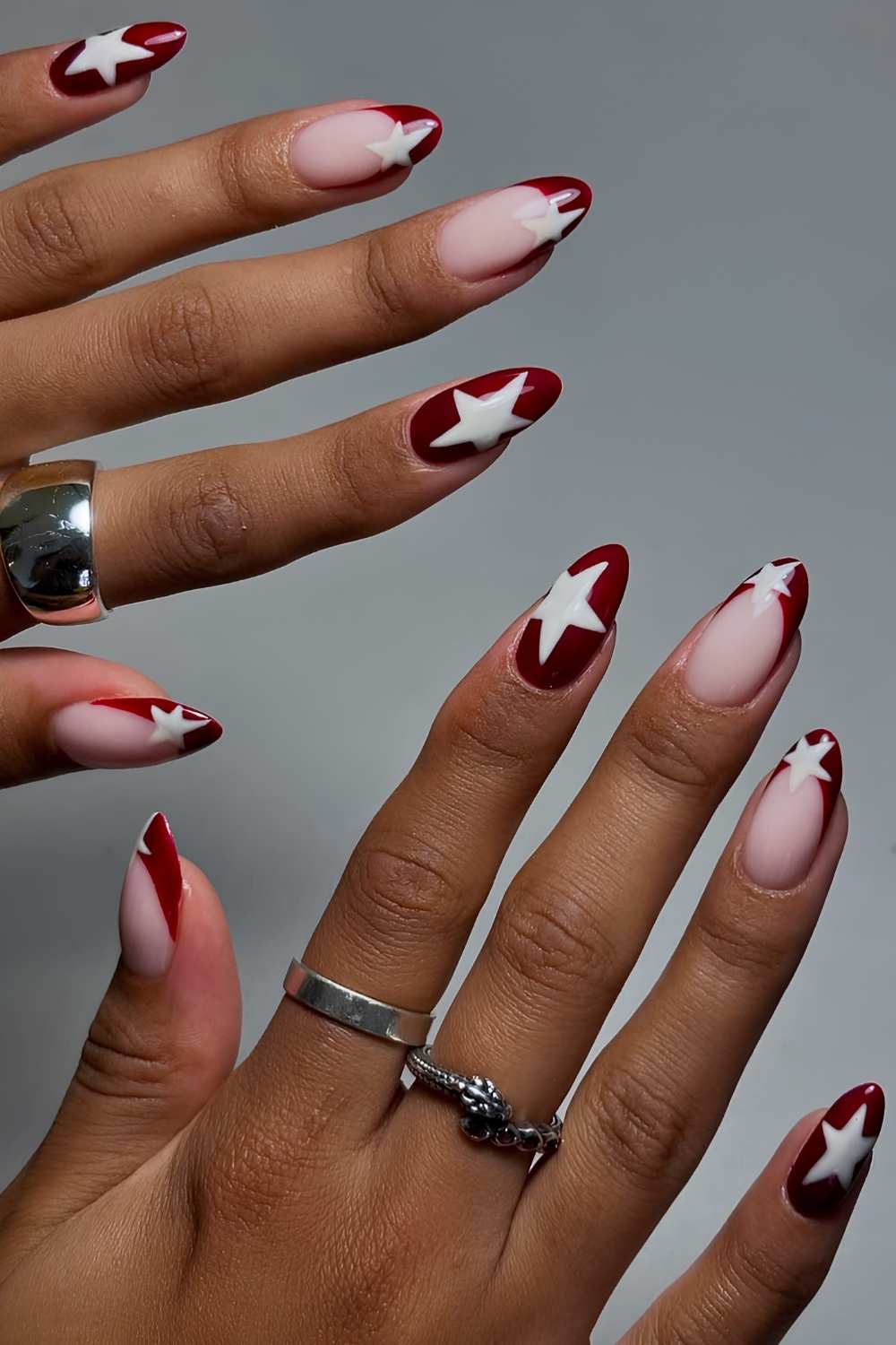 Dark red nails with white star art