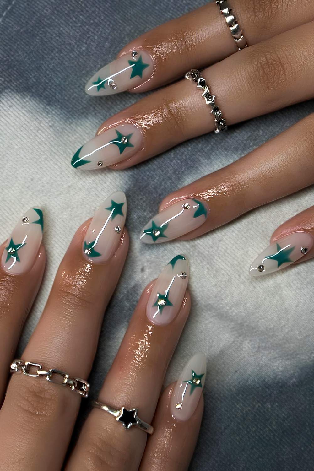 Milky white nails with green stars and gems