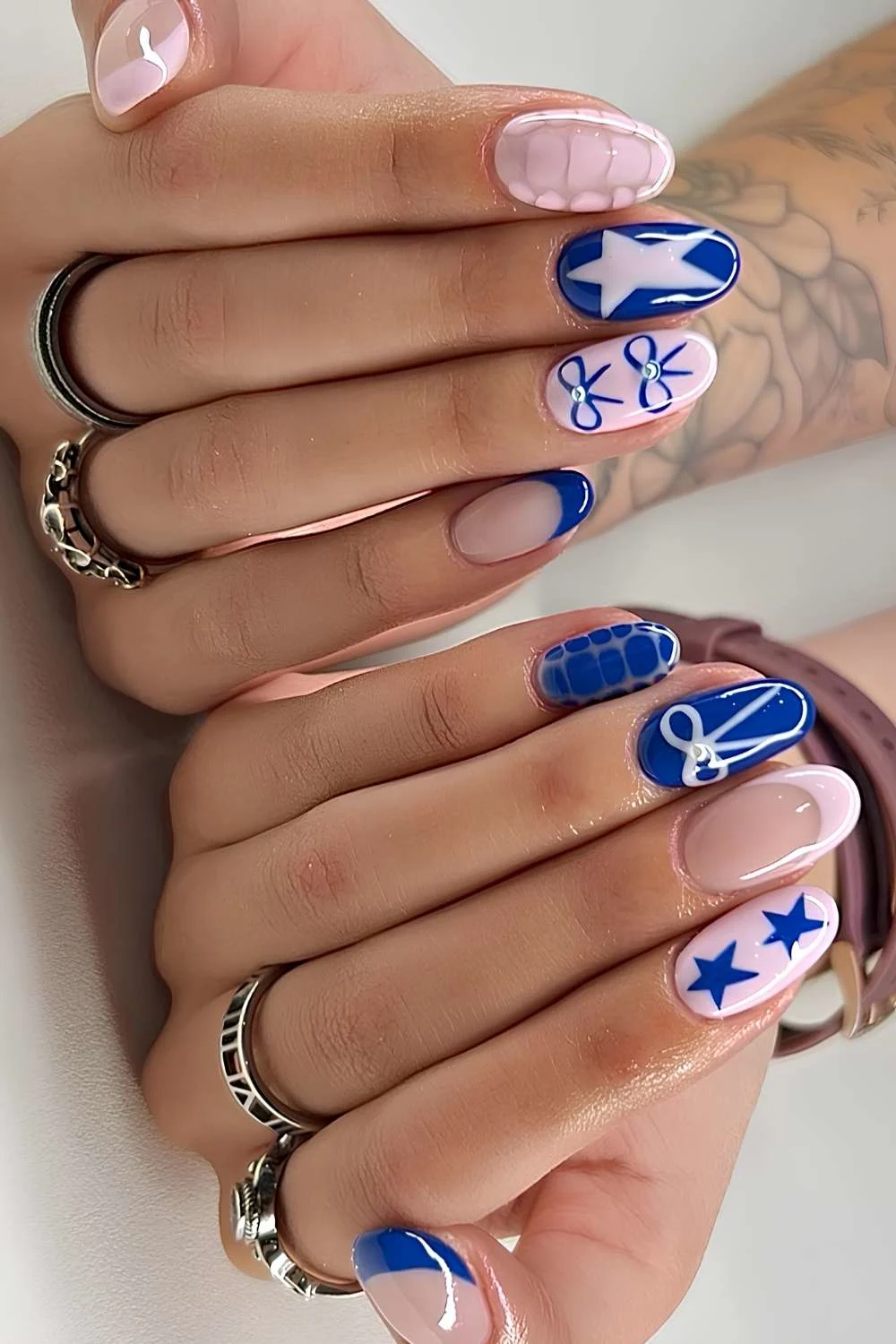Pink and blue nails with stars and bows