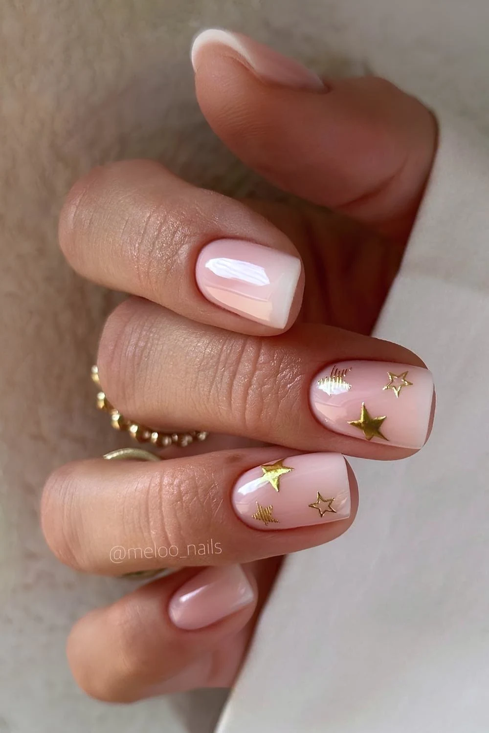 Pink and white ombre nails with gold stars