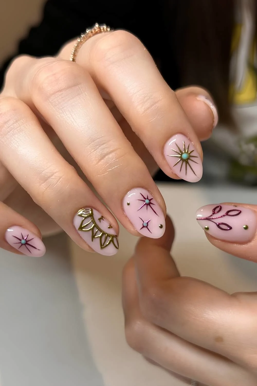 Pink nails with sun and star art