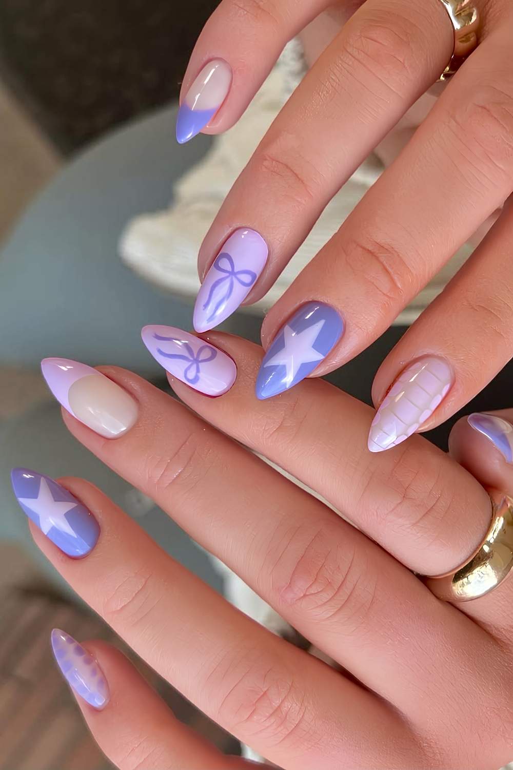 Purple and lilac nails with stars and bows