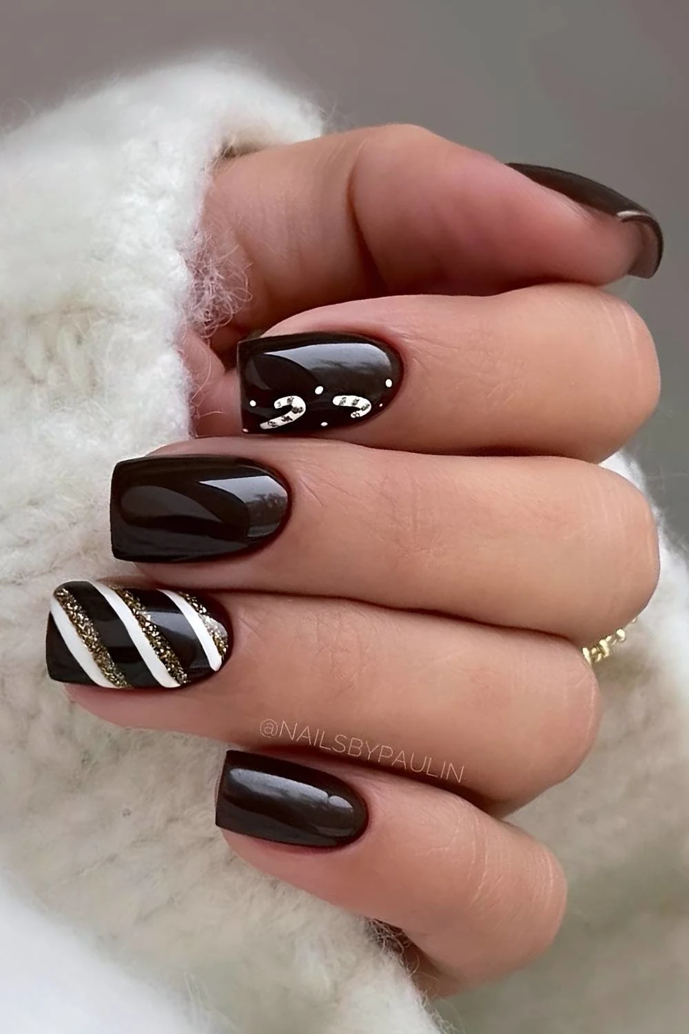 Dark brown nails with candy cane stripes