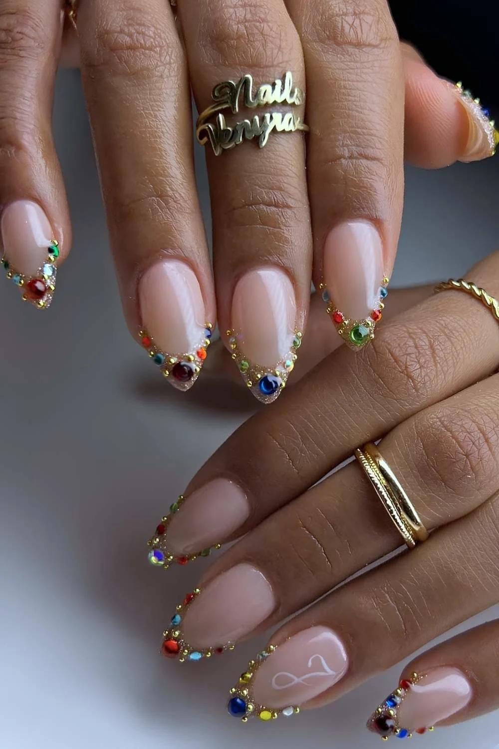 Gold French nails with colorful gems