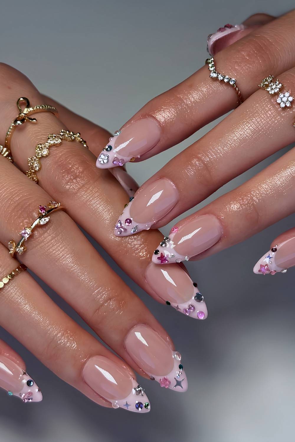 Pink French mani with colorful crystals