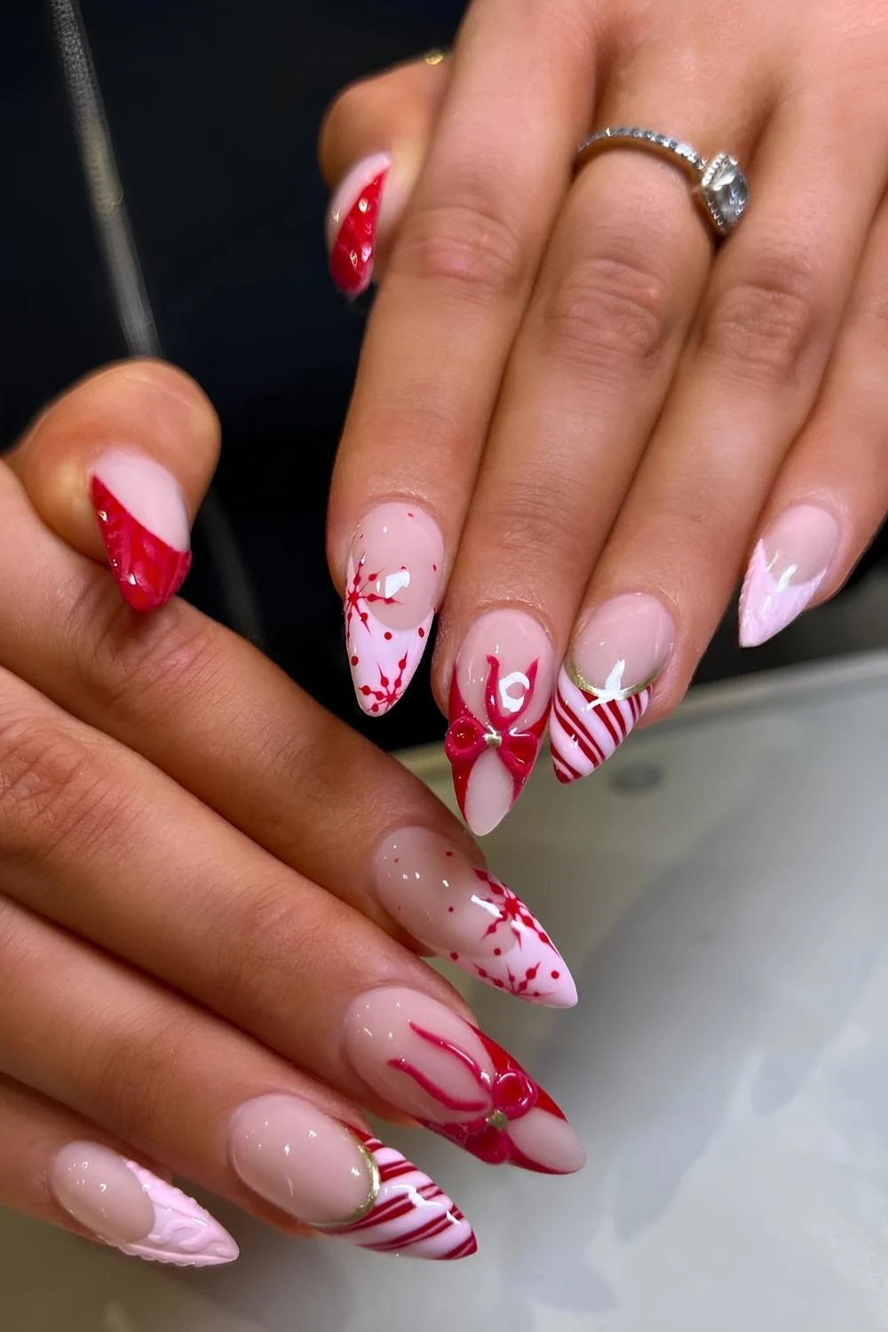 Pink and red nails with bows and candy canes