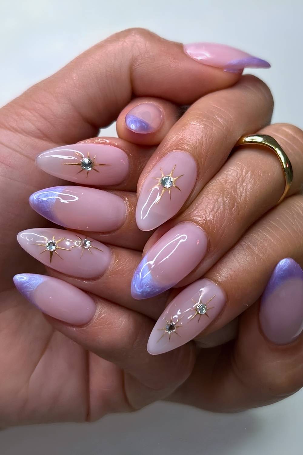 Purple French nails with star and gem accents
