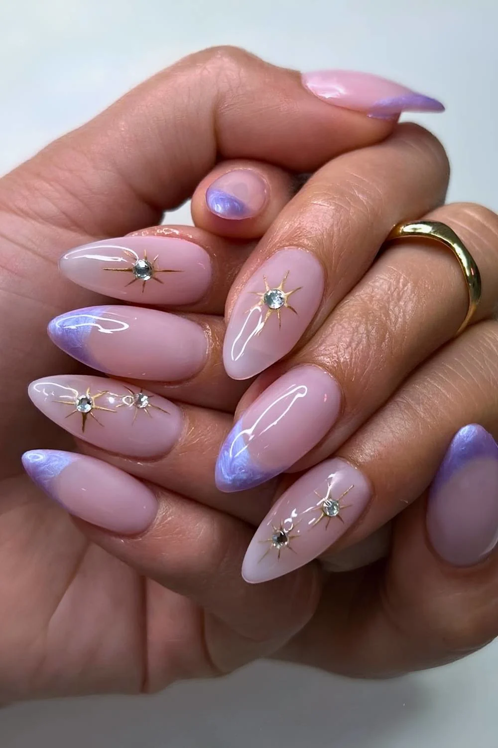 Purple French nails with star and gem accents