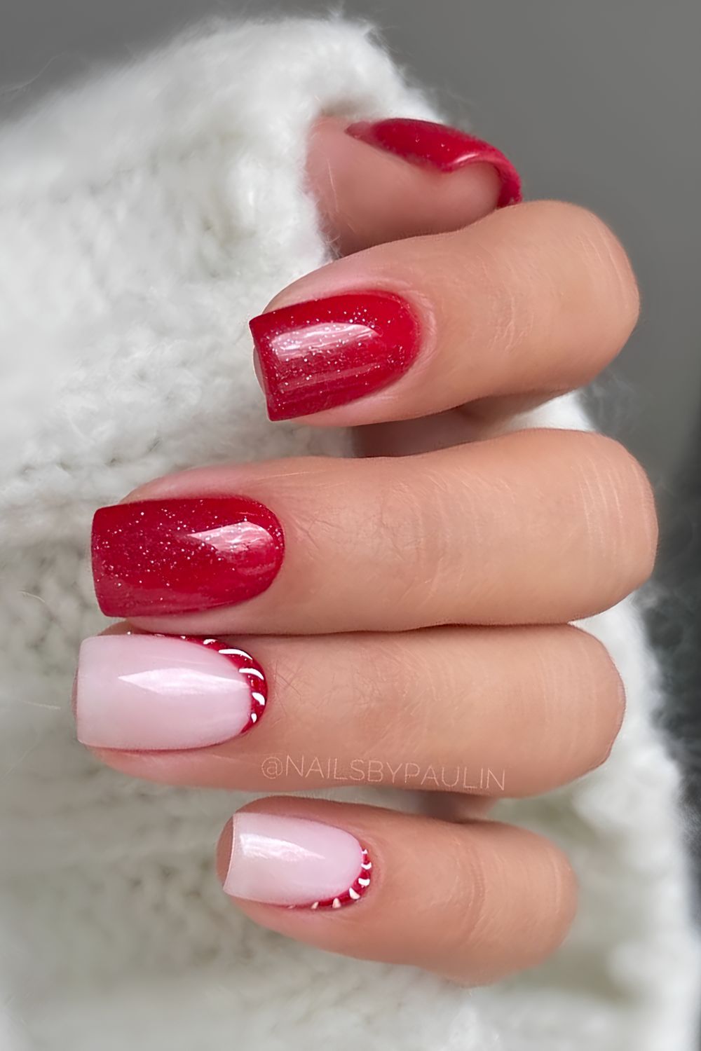 Shimmery red nails with minimalist candy cane art