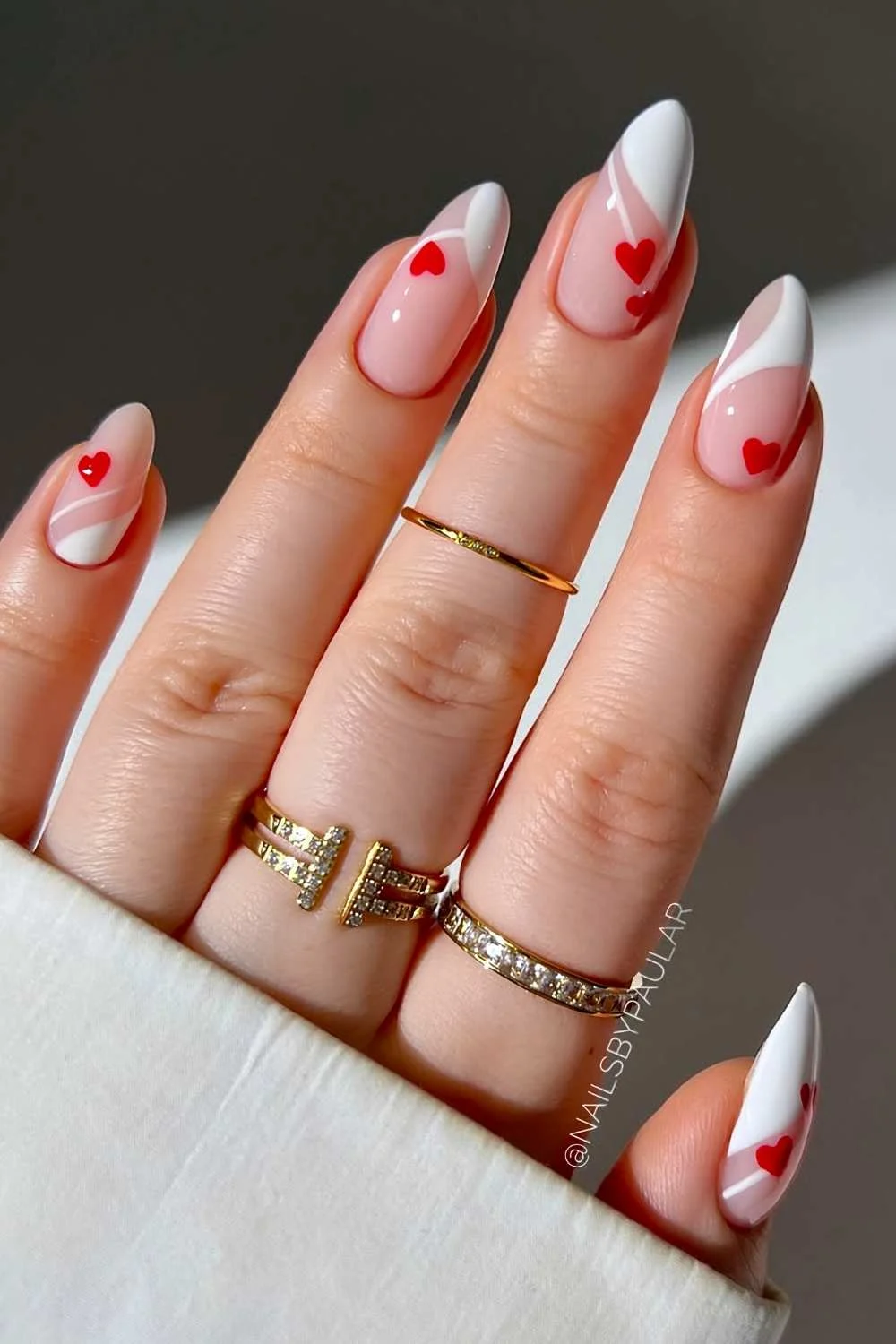 Abstract white French nails with red hearts