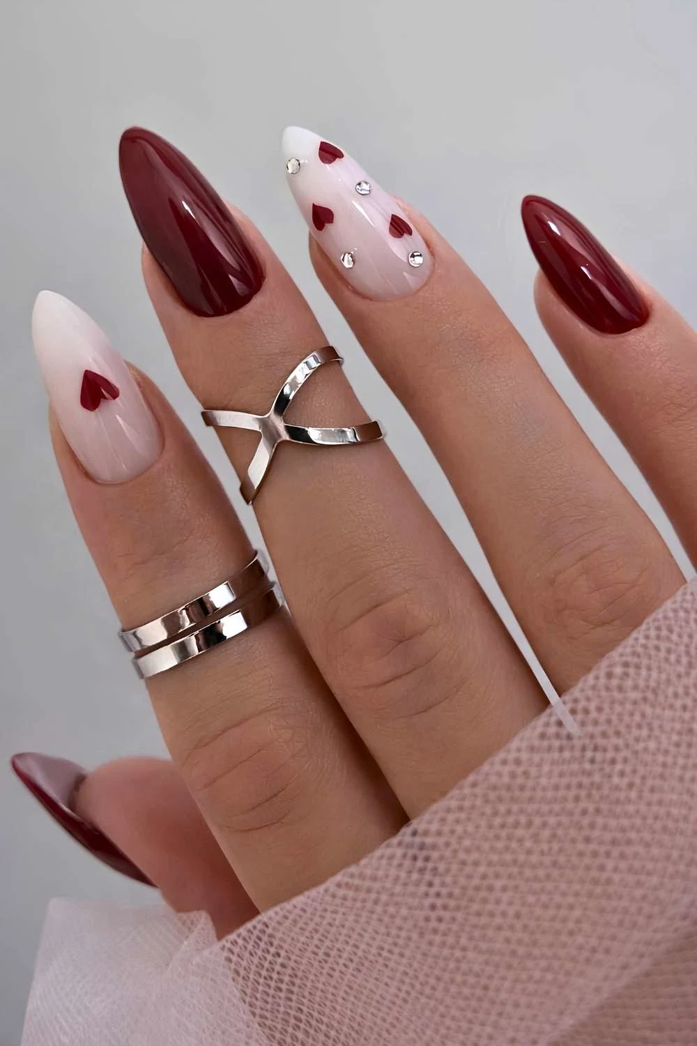 Burgundy and white mani with gems and hearts
