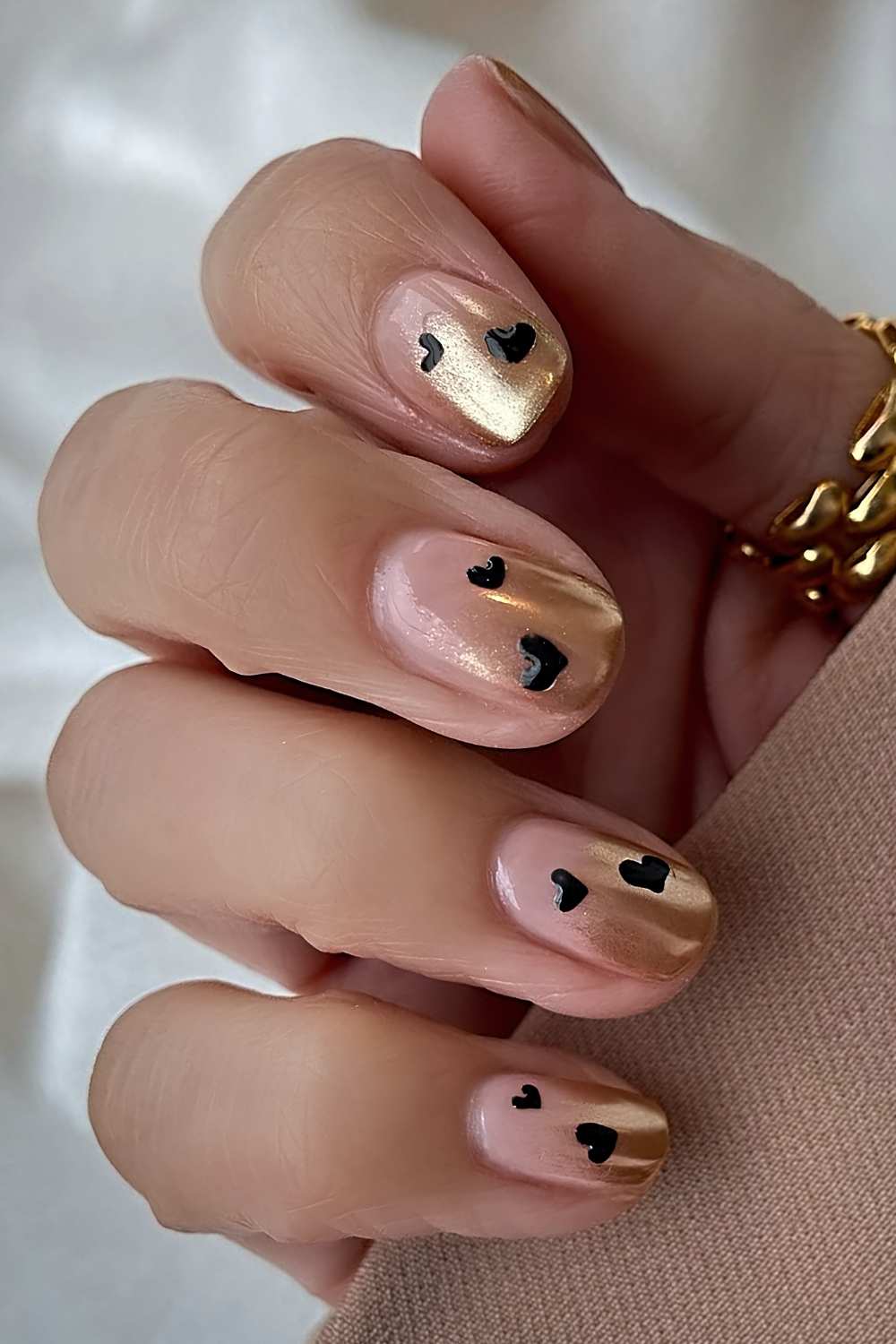 Gold ombre nails with black hearts